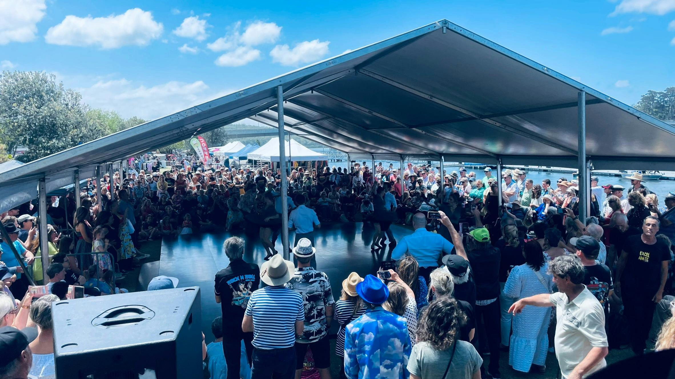 Crowd gather around the large outdoor dancefloor to watch the dancers