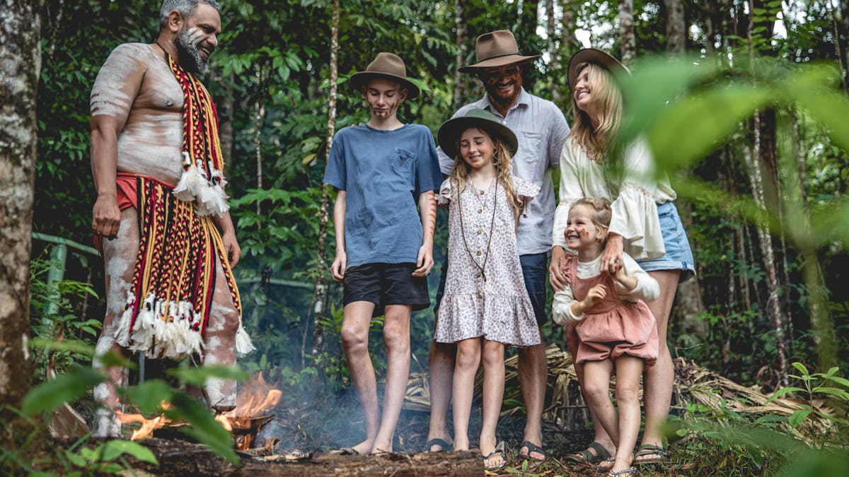 A group of visitors learning about the rainforest and aboriginal traditions with an aboriginal guide