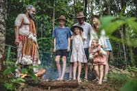 A group of visitors learning about the rainforest and aboriginal traditions with an aboriginal guide