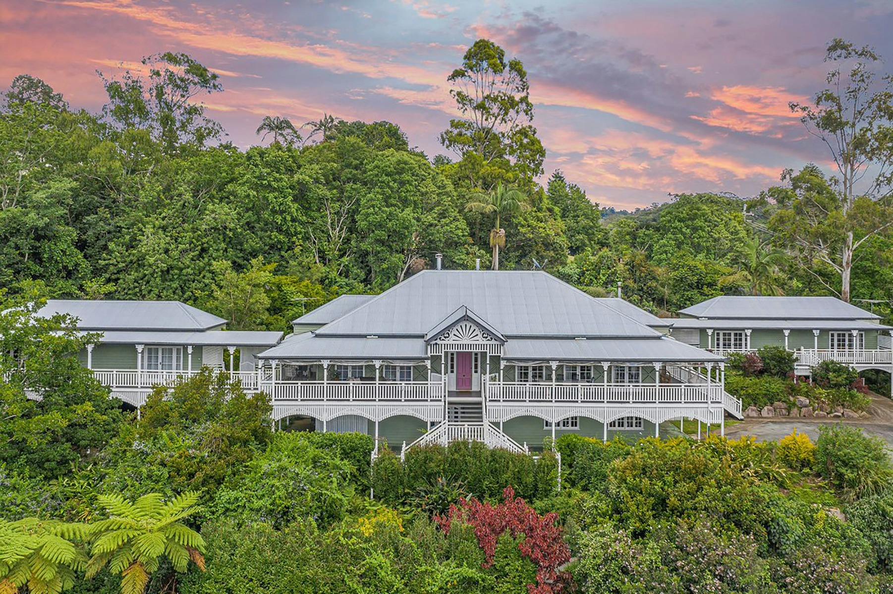 Beautiful old Queenslander style white lodge set amongst lush green gardens