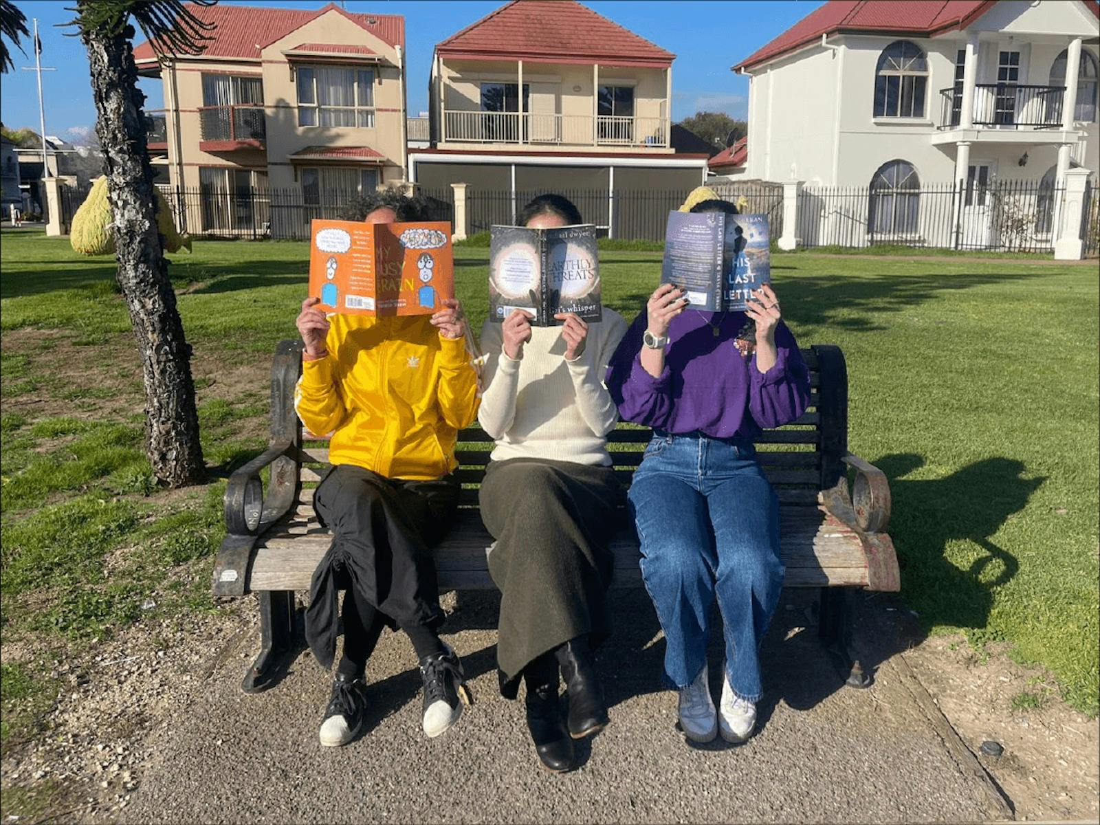 People on park bench reading  Adelaide indie authors  books