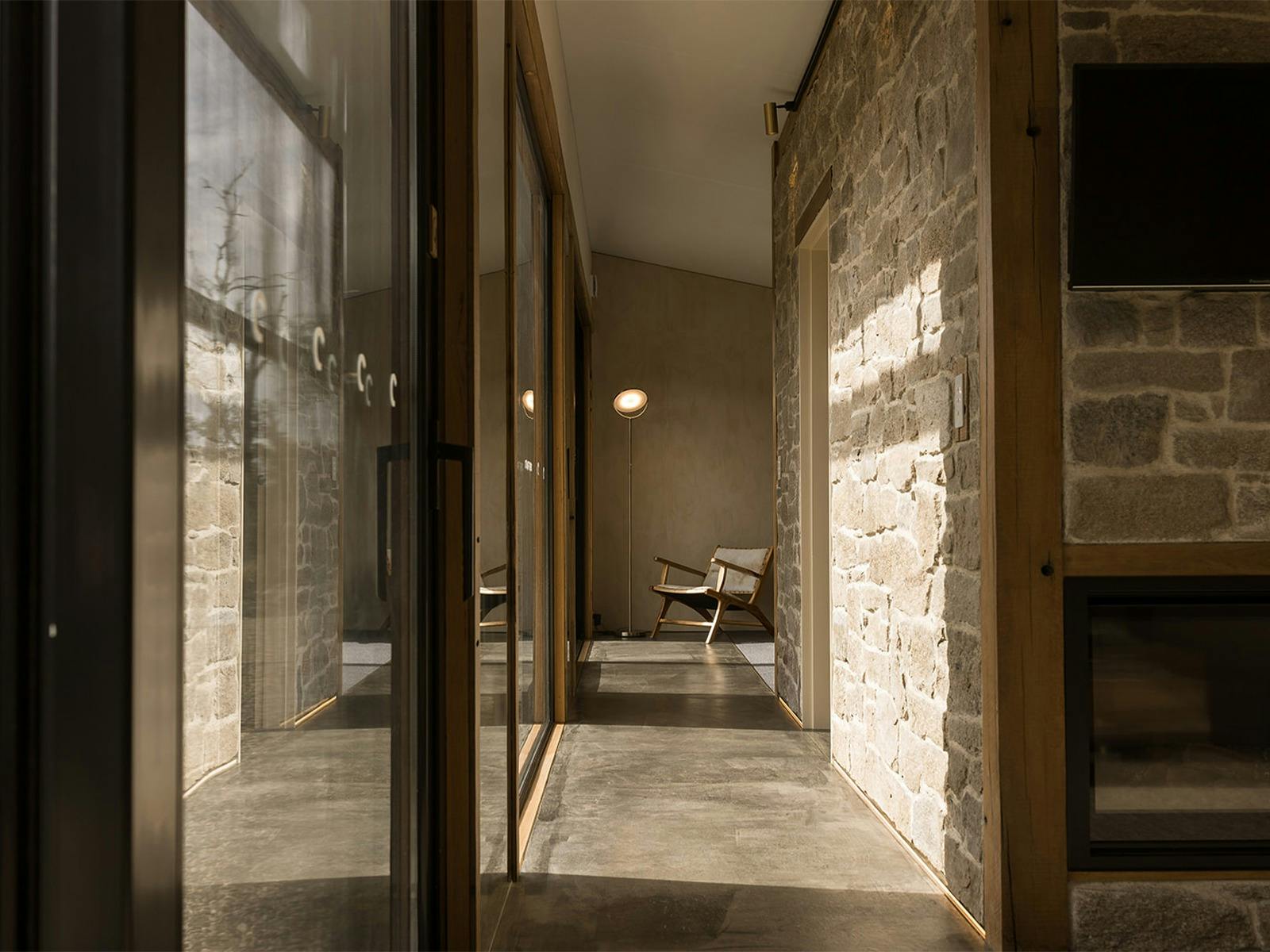 stone walkway with feature chair and windows