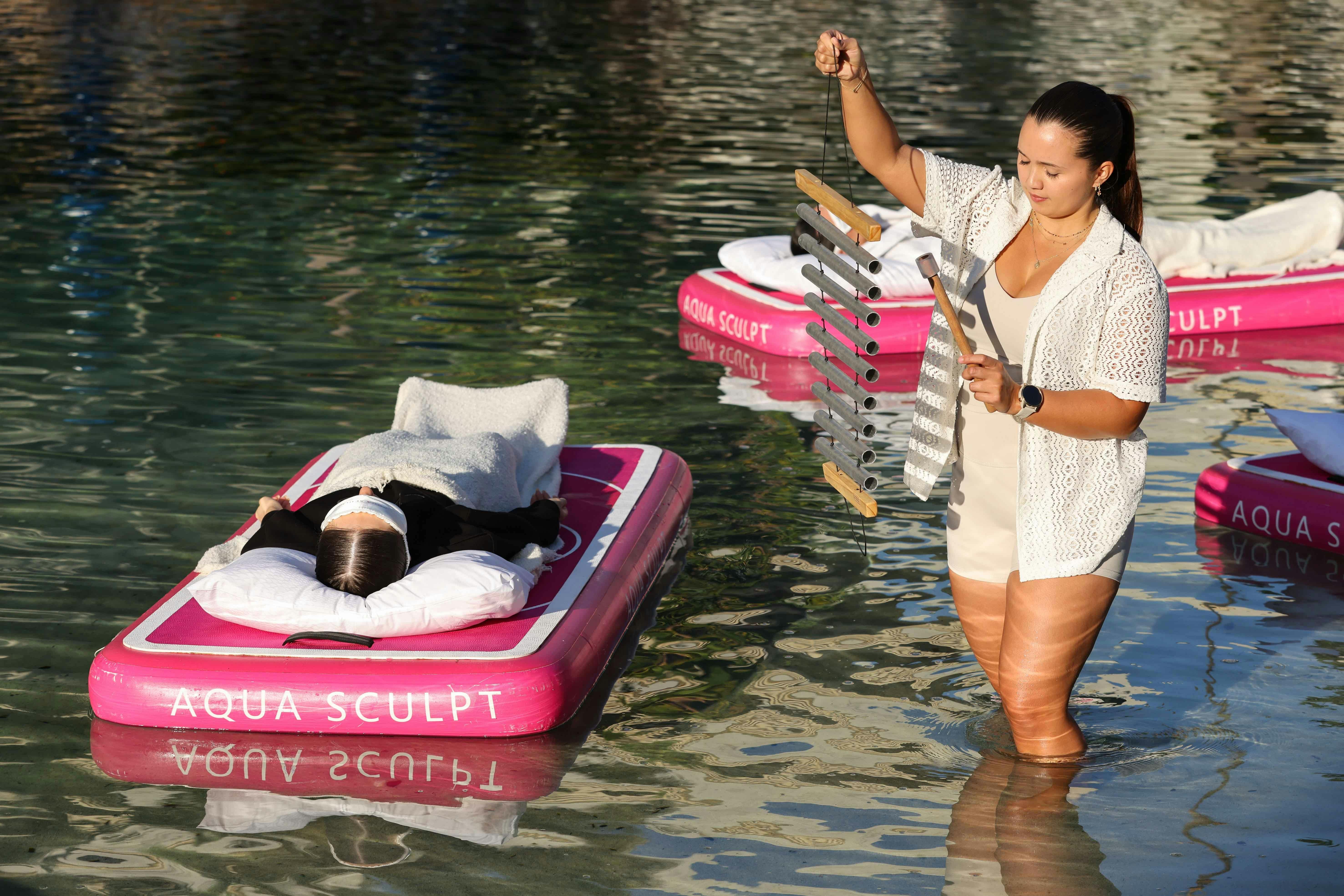 Two participants floating at an Aqua Sculpt sound bath at the JW Marriott Gold Coast Resort & Spa