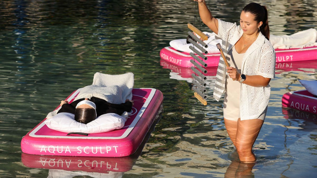Two participants floating at an Aqua Sculpt sound bath at the JW Marriott Gold Coast Resort & Spa