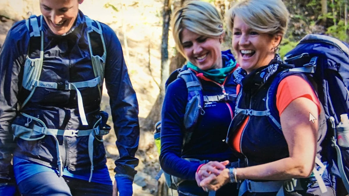 Three women connecting and laughing at Mt Coot thaa