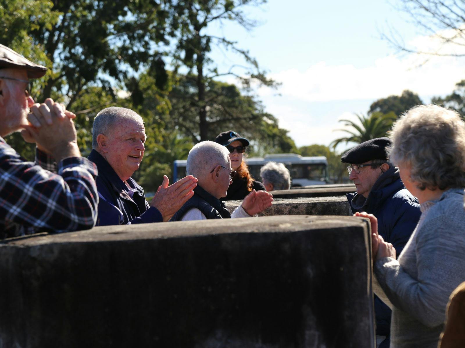 Visitors at a heritage cemetery tour near historic stone structures of the Mortuary Station