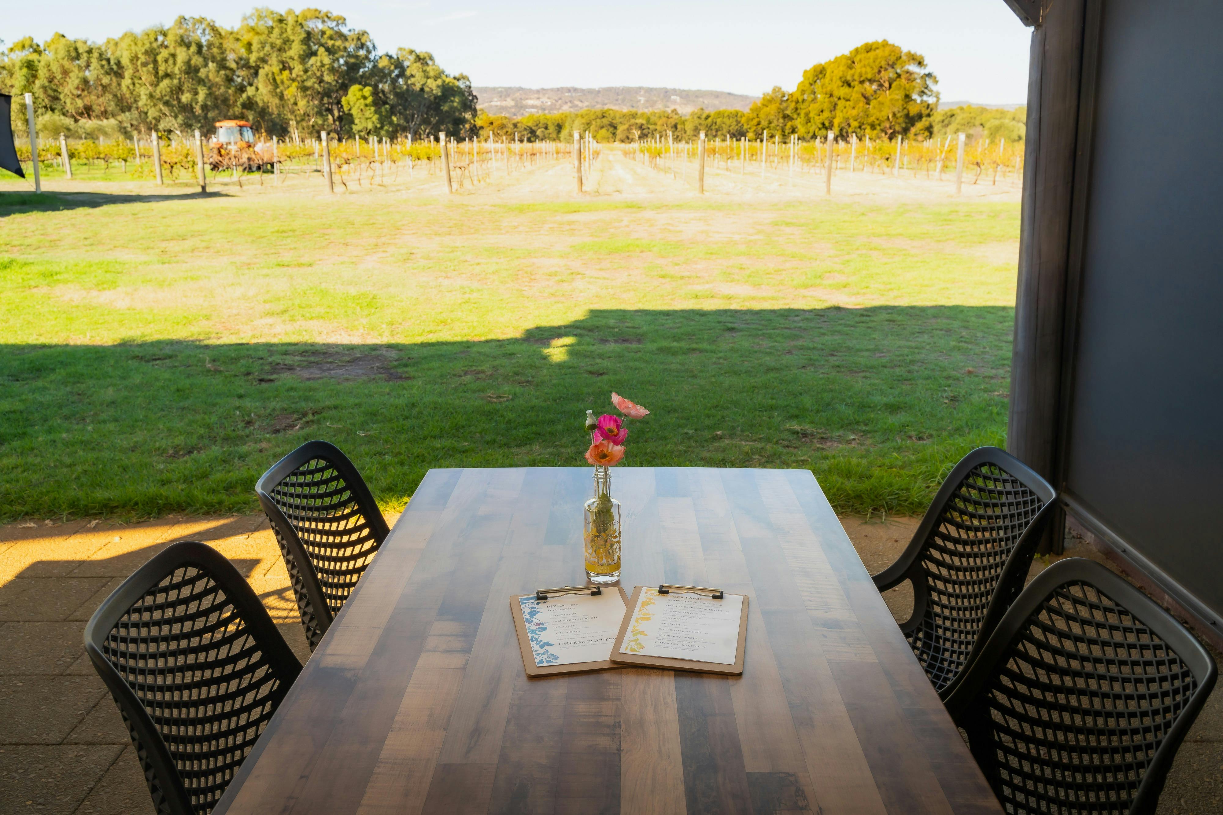 Outdoor seating overlooking the vineyard at AmberChes Spirits Distillery