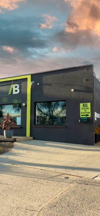Wide shot of outside of building showing the ALLBIDS and CARBIDS signage