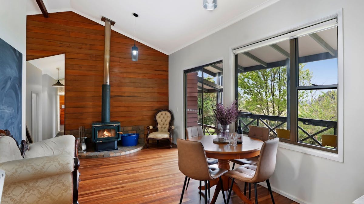 Breakfast nook with fireplace , balcony access and views of the Glass House Mountains