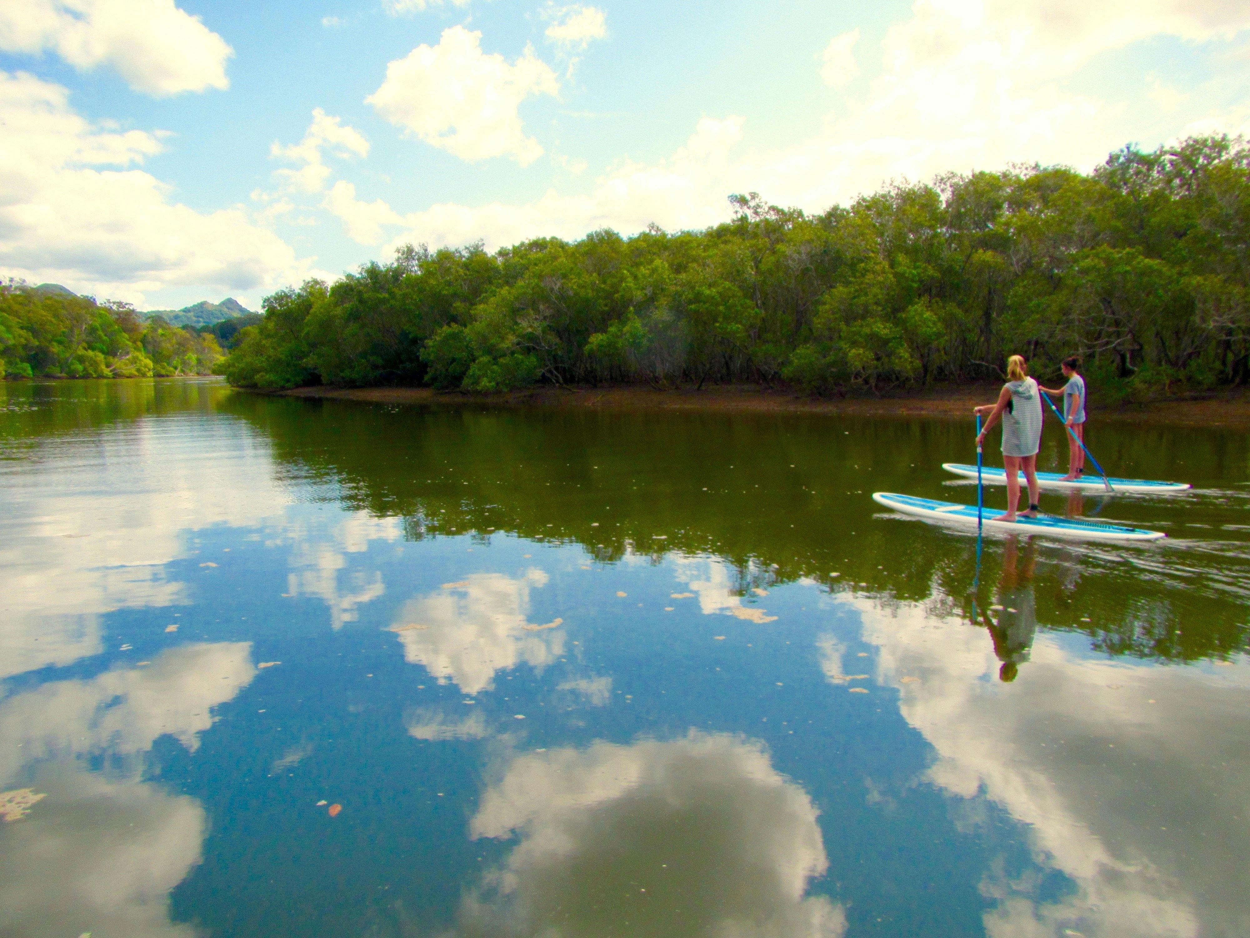 Stand up paddle tour Byron Bay friends paddling on cloud reflections