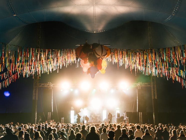 A crowd in a big top tent