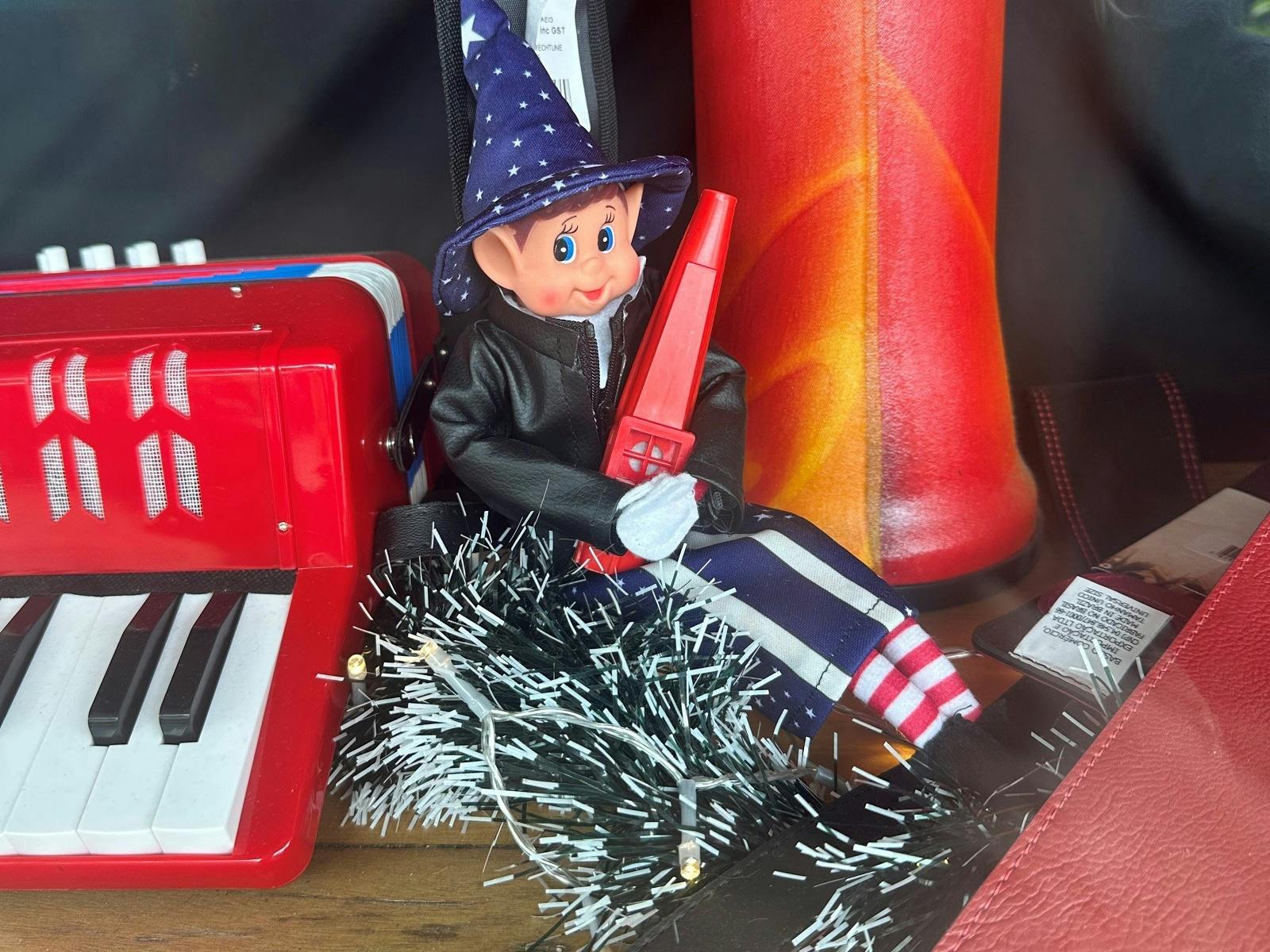 Cheeky elves hiding in shop windows