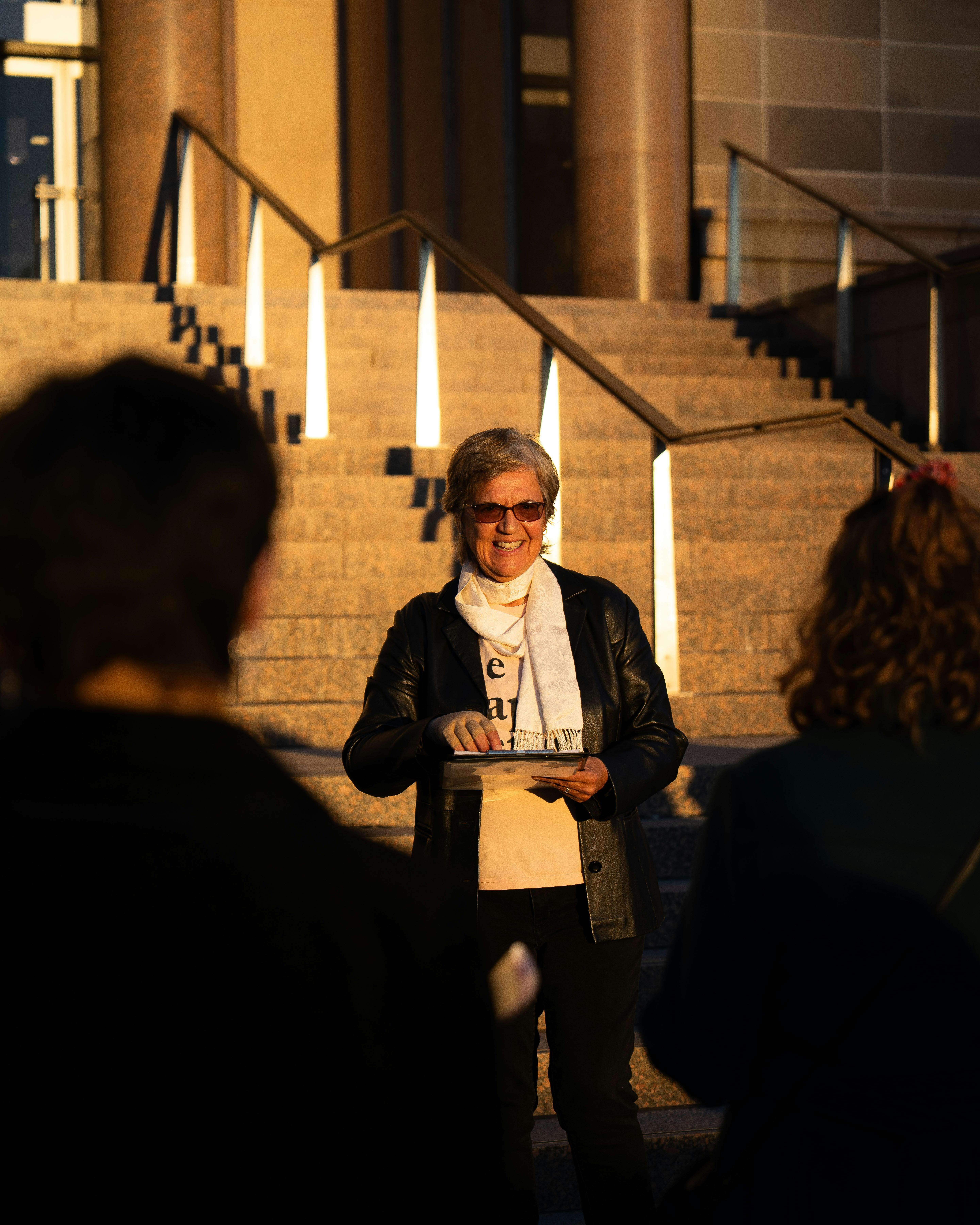 She Shapes History tour guide presenting to the group of engaged guests