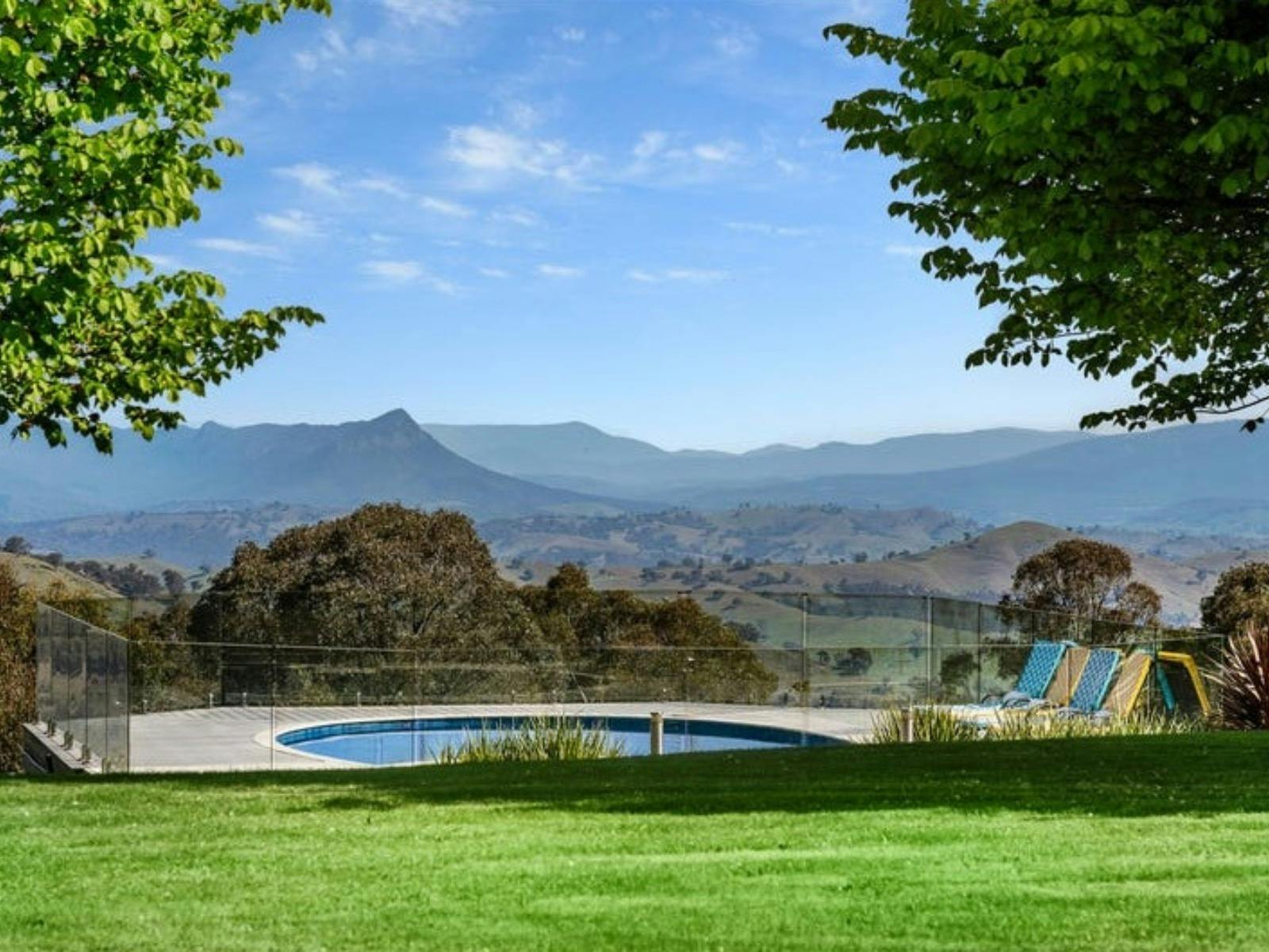 Swimming pool with mountain and countryside views at Sambar Ridge in Alexandra, Victoria.