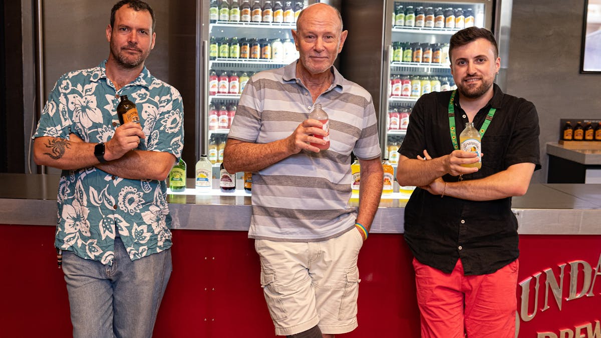 Three guests sample Bundaberg brews at the tasting bar – flavour, fun, and local charm!