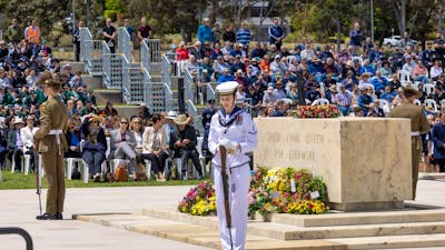 servicepersons standing at each corner of the stone of remembrance