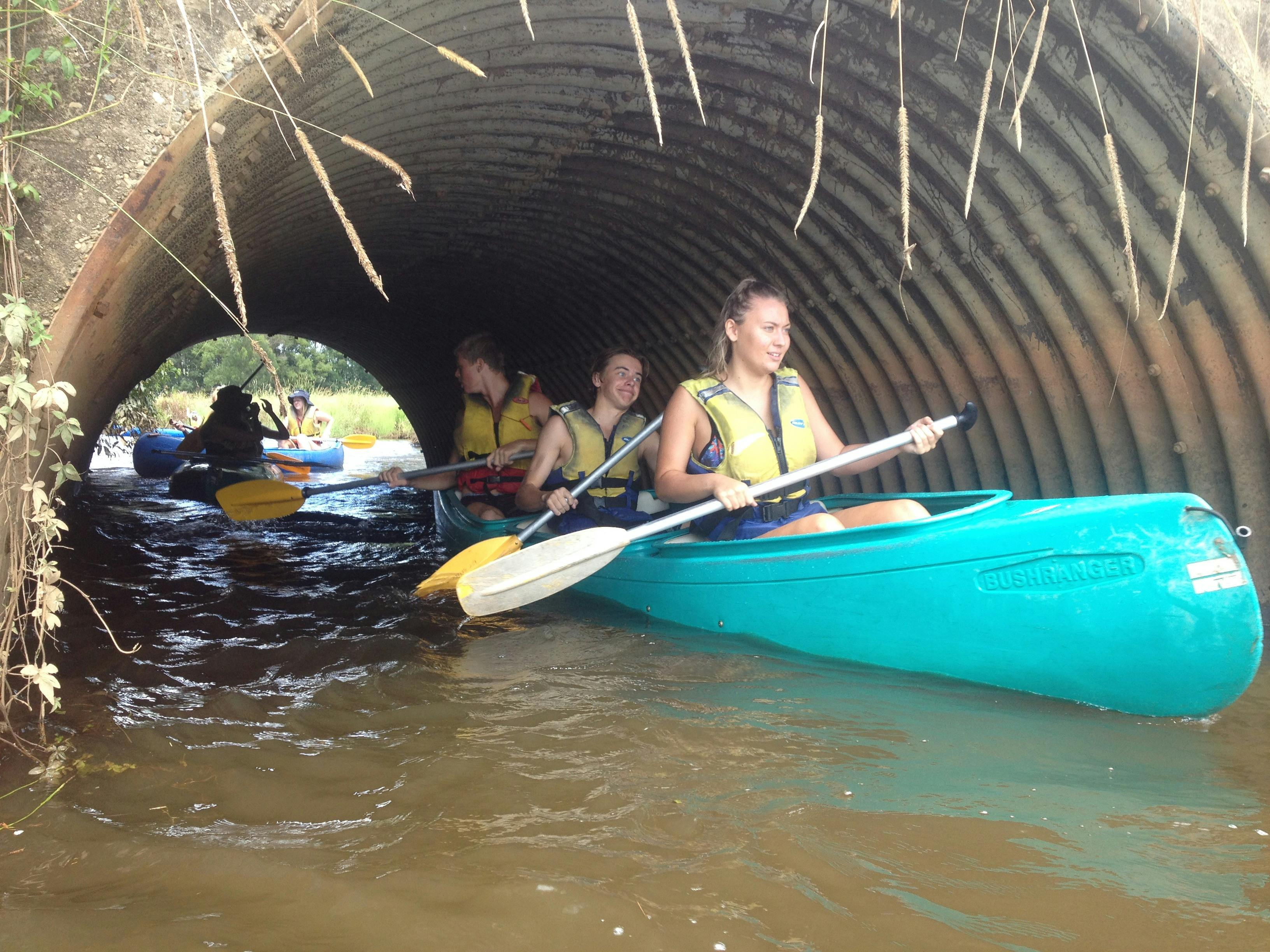 Group of school students on a field trip - paddling through a tunnel with Bellingen Canoe Adventures