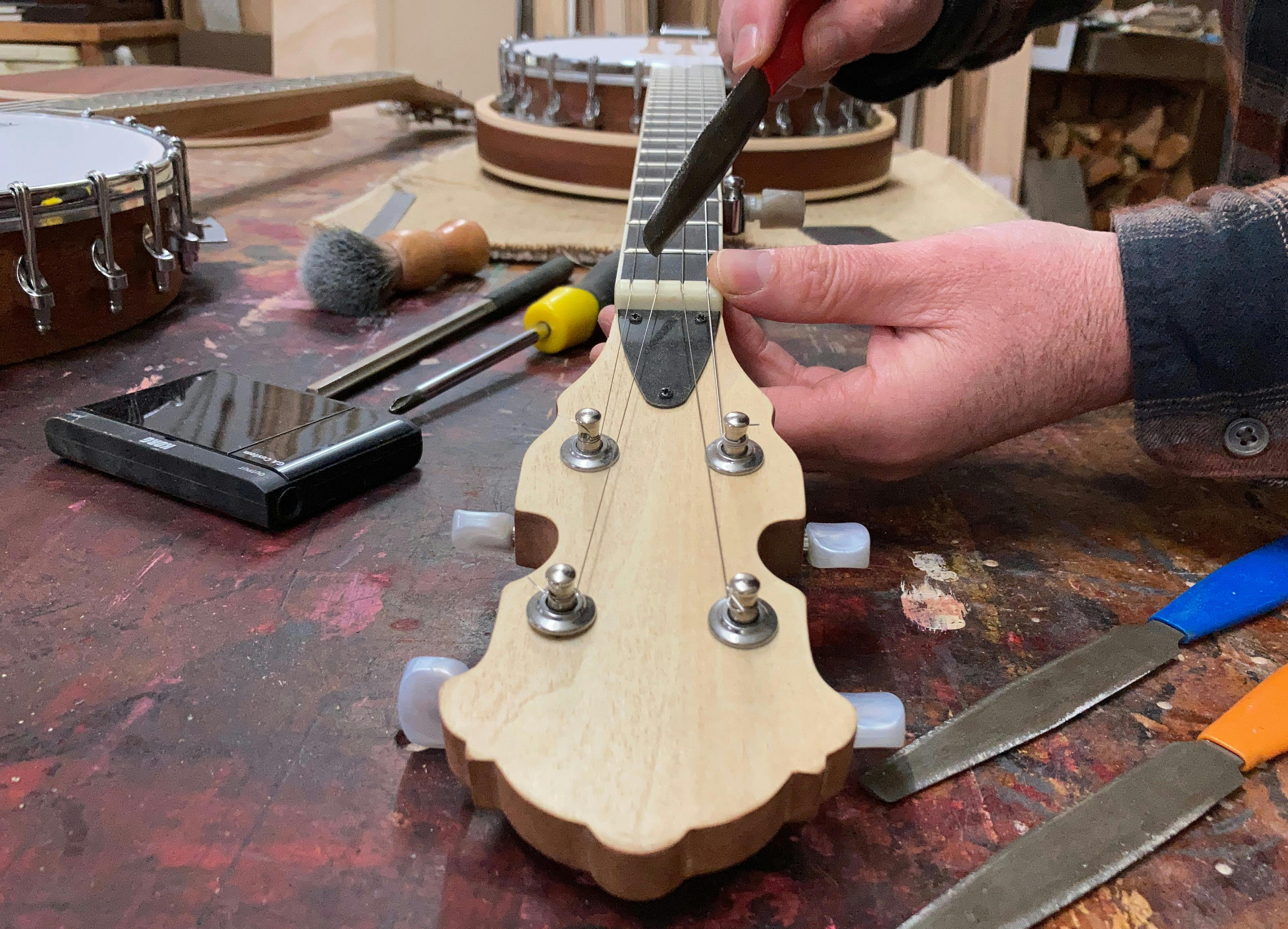 Luthier Nick Carpenter holding a Banjo