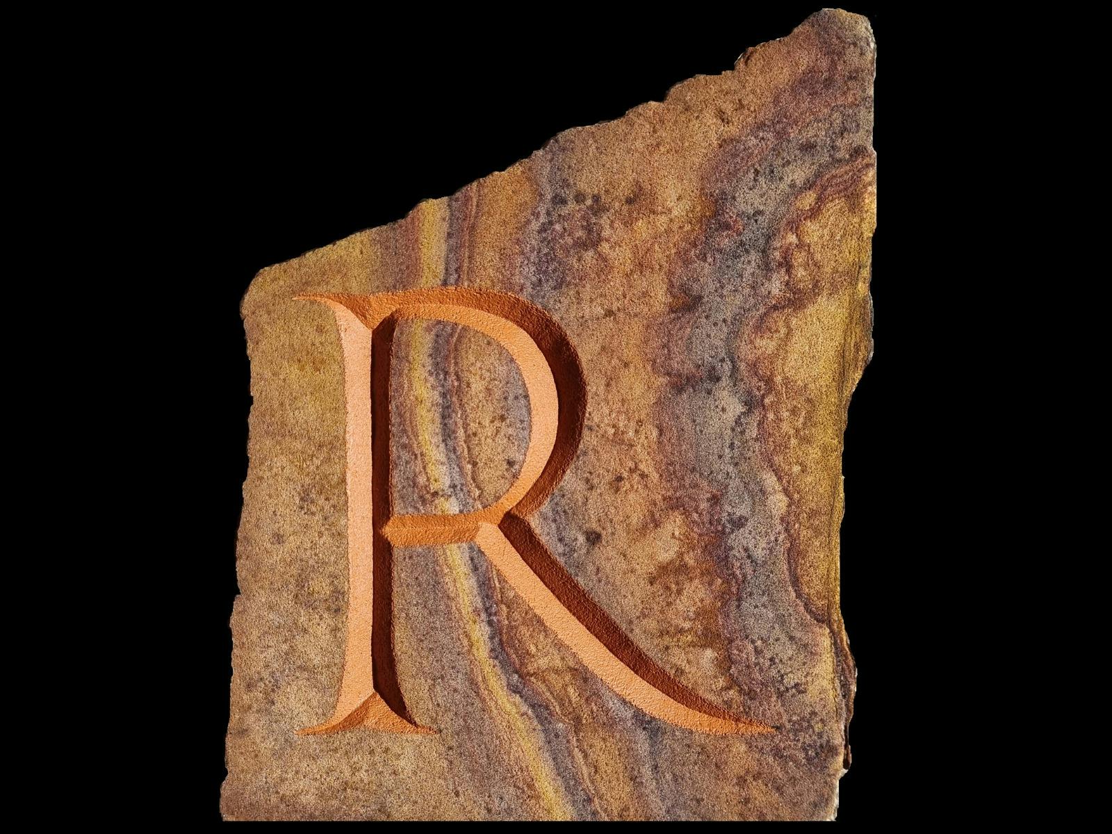 Letter R carved into a stone