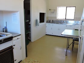 A fully equipped kitchen featuring two stoves, two fridge-freezers, microwave, all cooking needs.