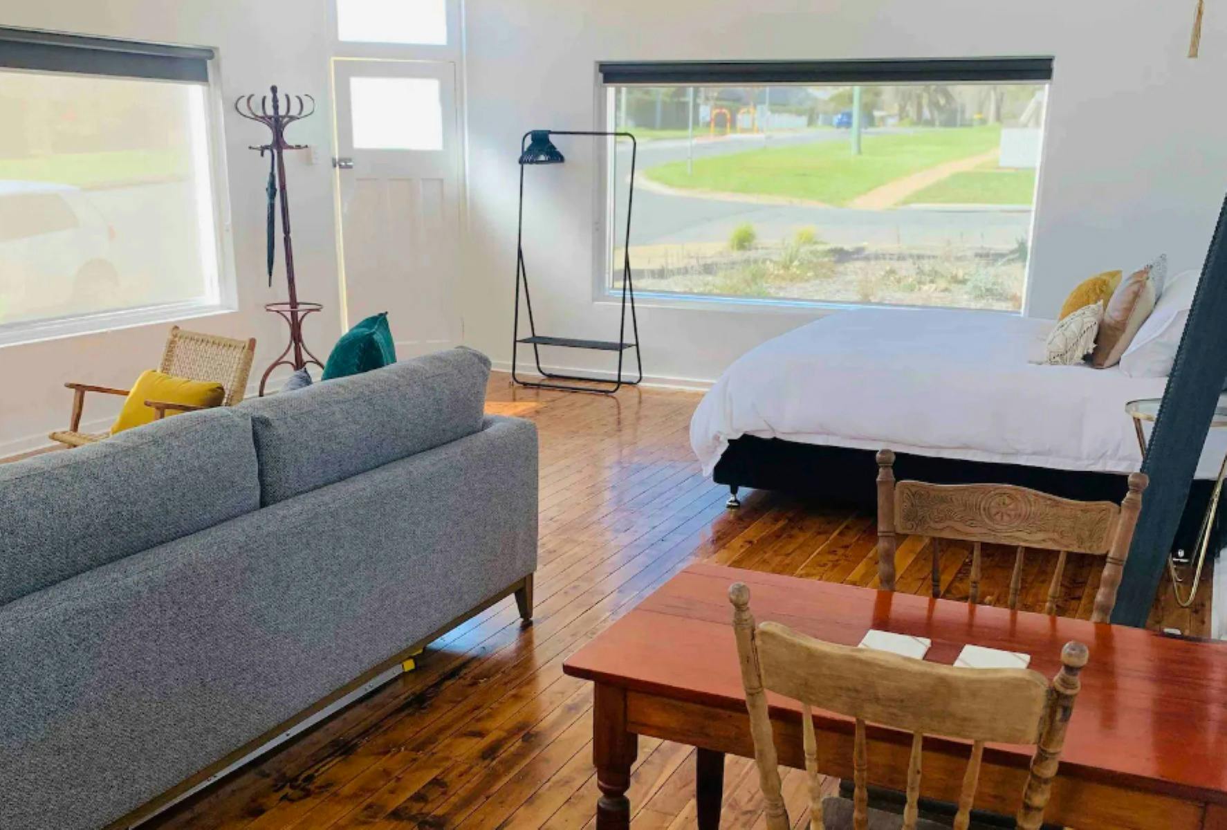 lounge, bed and table with chairs with large window