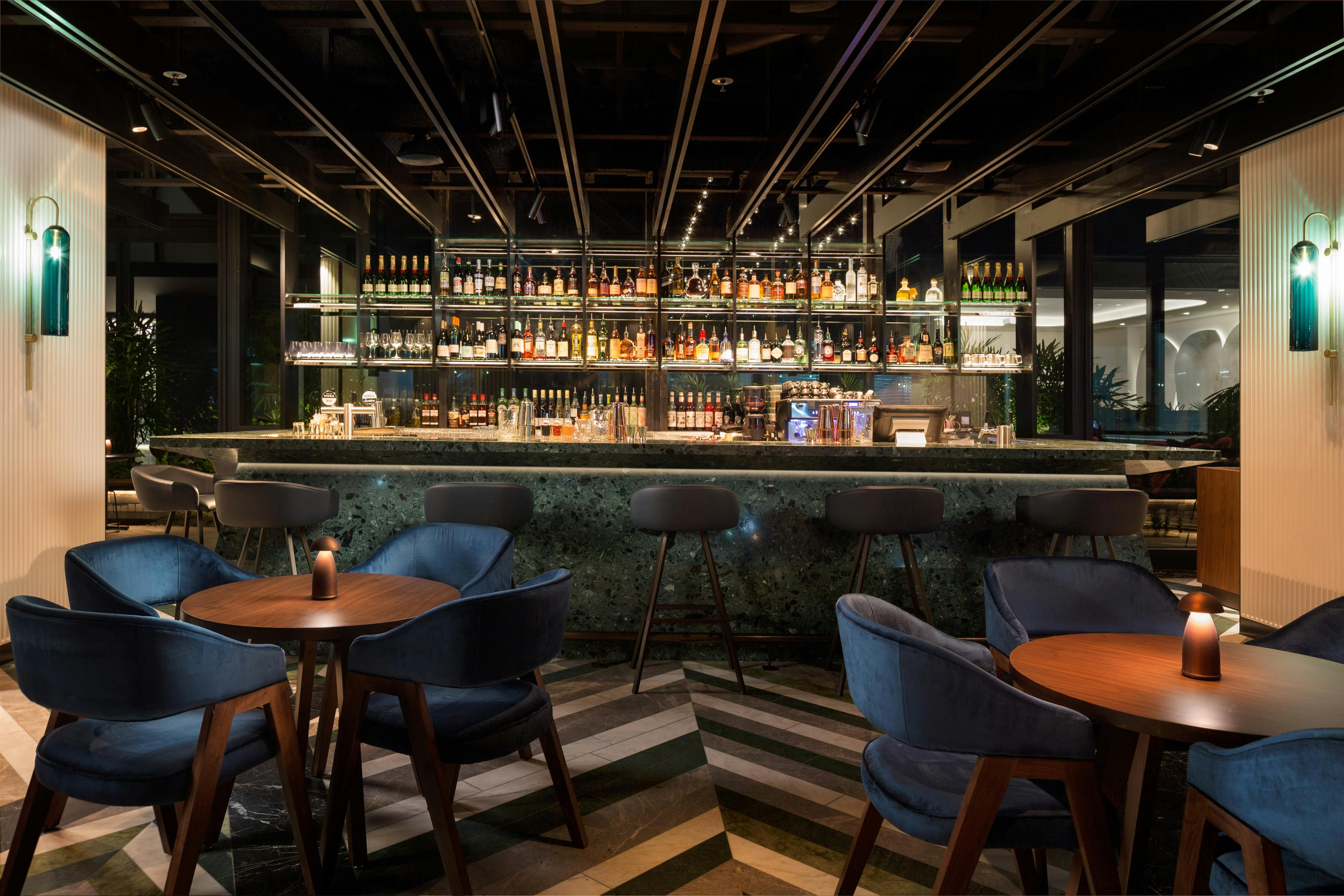 Solander Bar offers bespoke botanical-inspired cocktails served from the emerald green terrazzo bar.