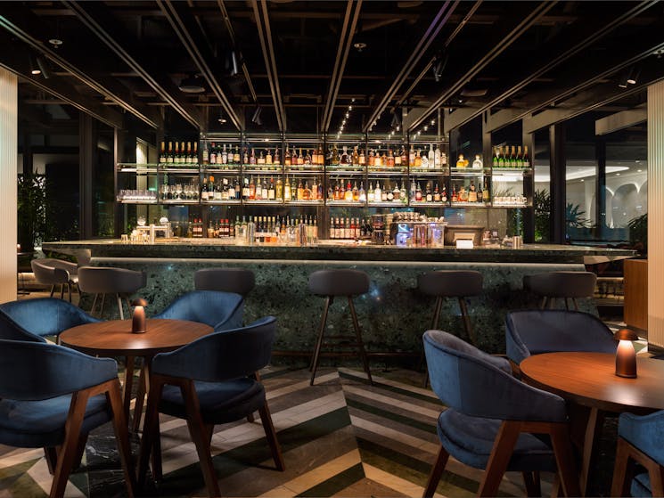 Solander Bar offers bespoke botanical-inspired cocktails served from the emerald green terrazzo bar.