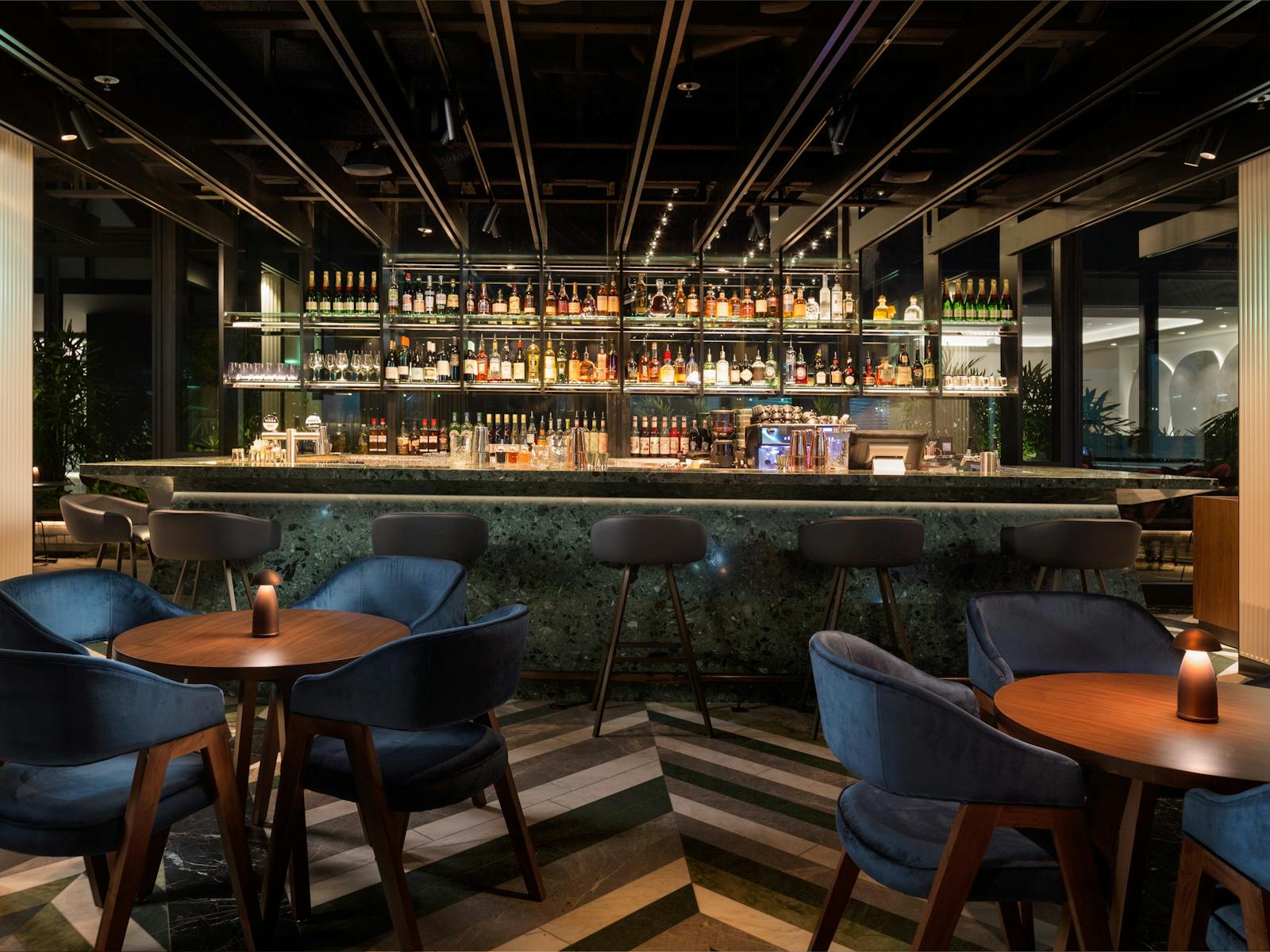 Solander Bar offers bespoke botanical-inspired cocktails served from the emerald green terrazzo bar.