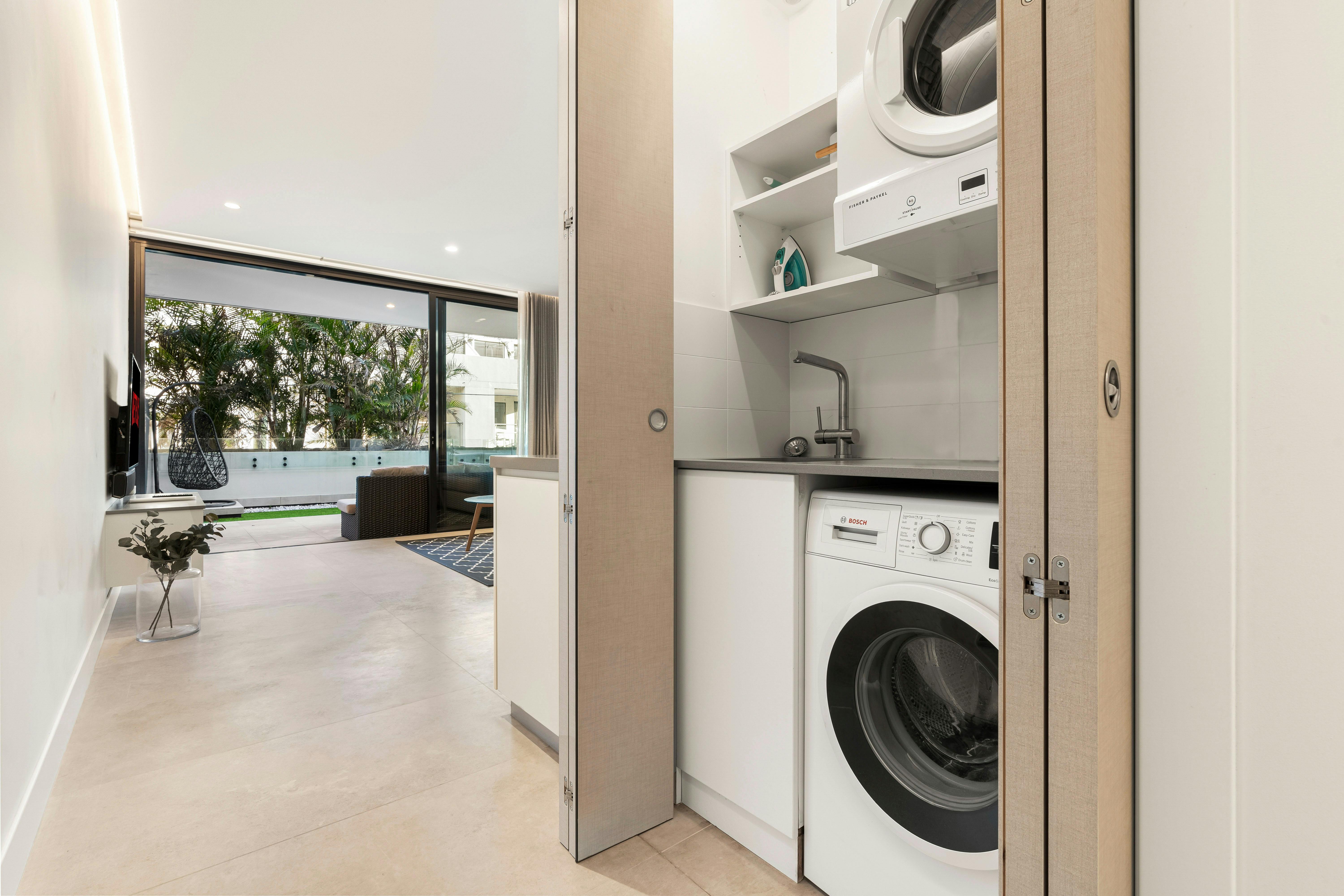 Laundry area featuring a washing machine and a view of the outdoor space.