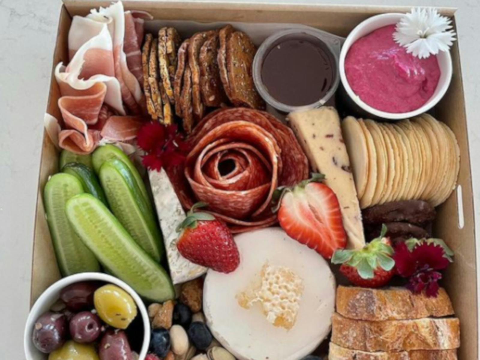 A colourful platter of fruit, cheeses and crackers