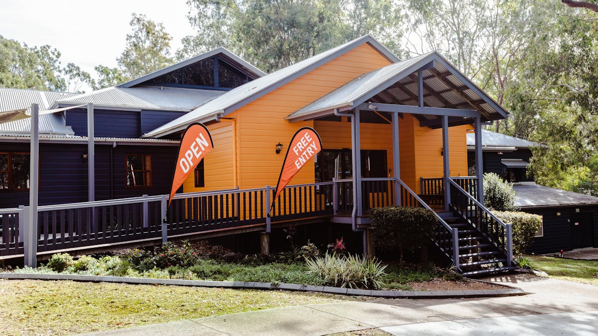 Orange and grey building with flags outside