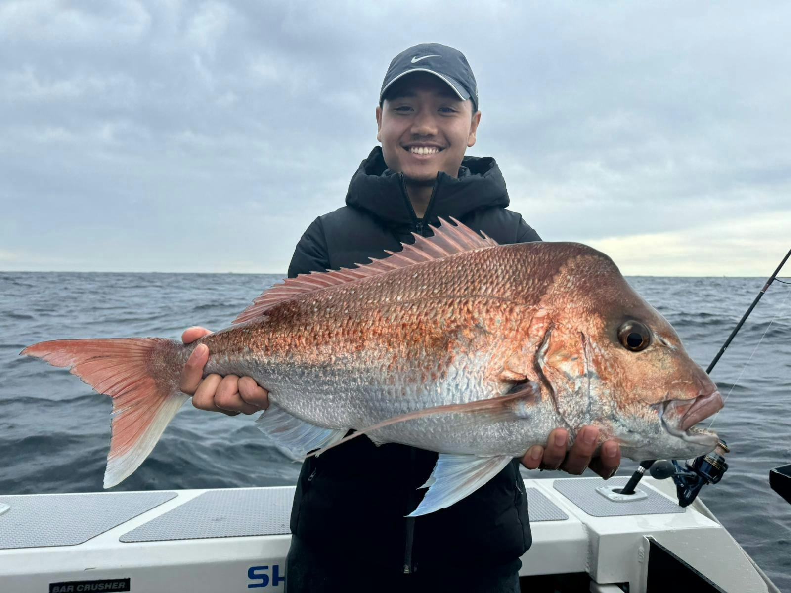 Reel Adventure Fishing - an angler holding a huge Snapper caught in Sydney Fishing Charter