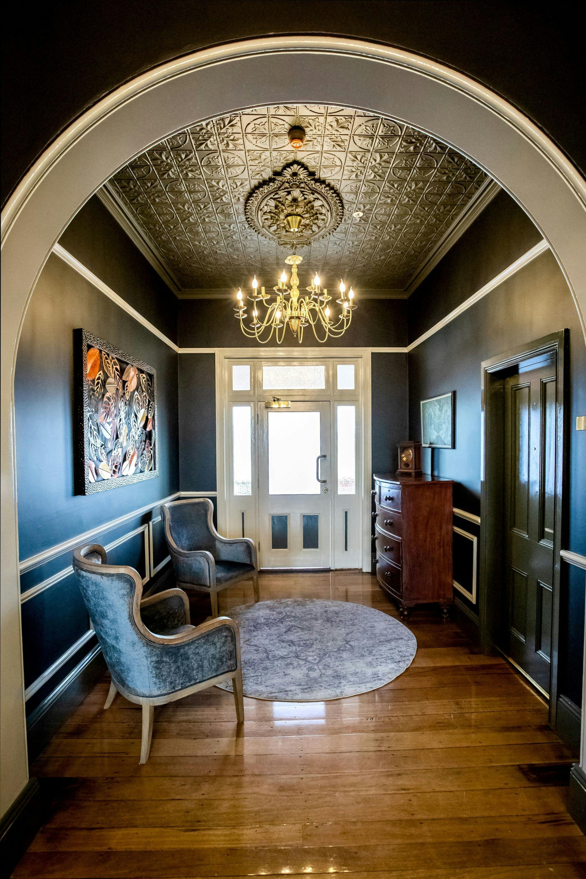 Foyer with chairs and chandelier