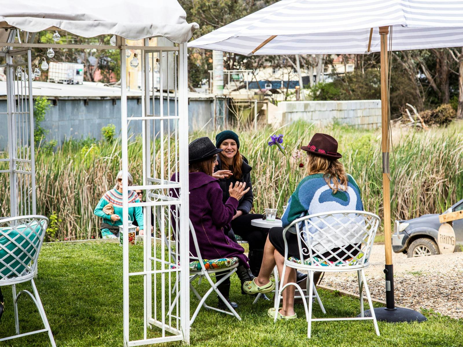 Group of girls getting together for a guided spirits tasting in the garden at Ladbroken distillery