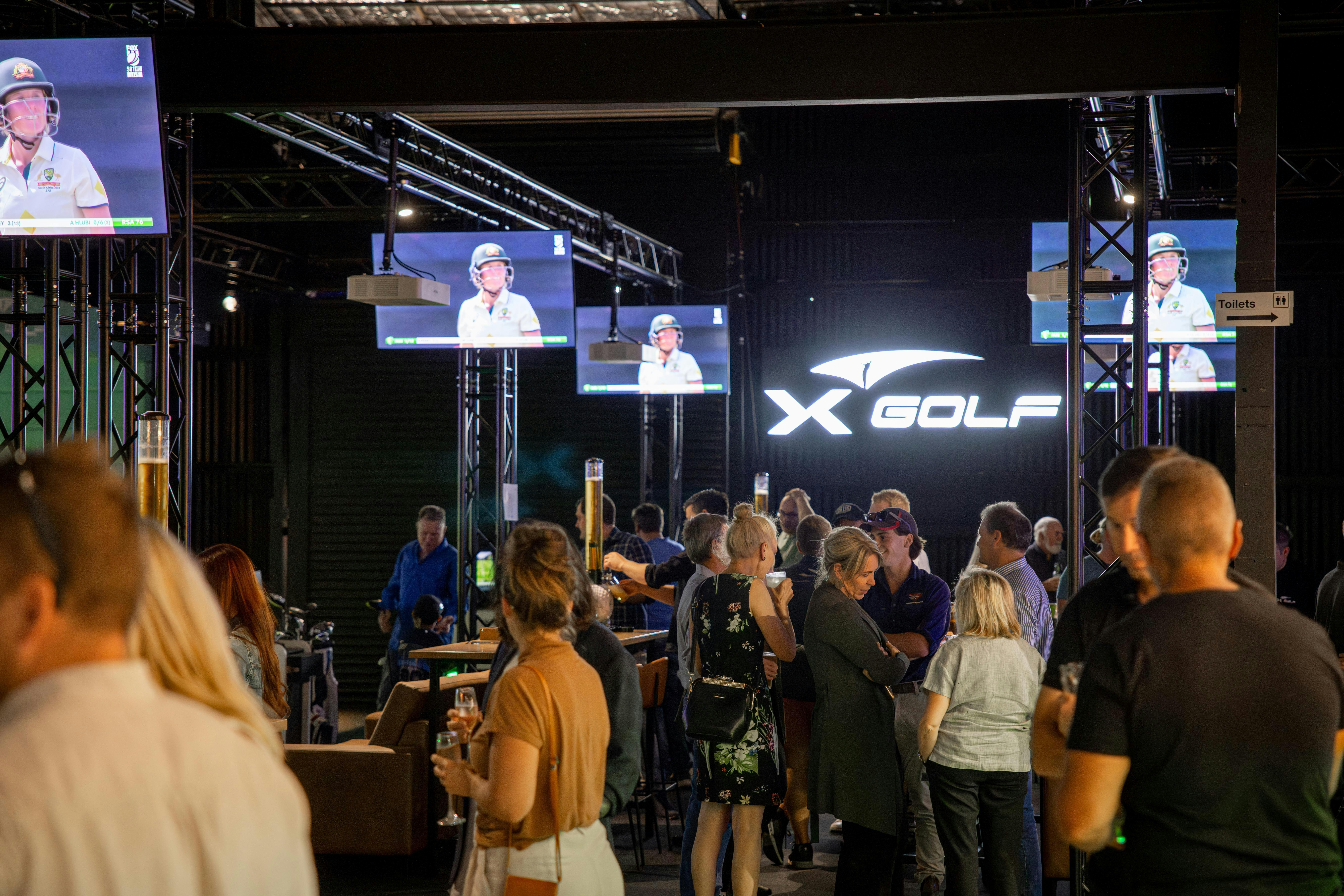 People Gathering Inside X-Golf Launceston Venue