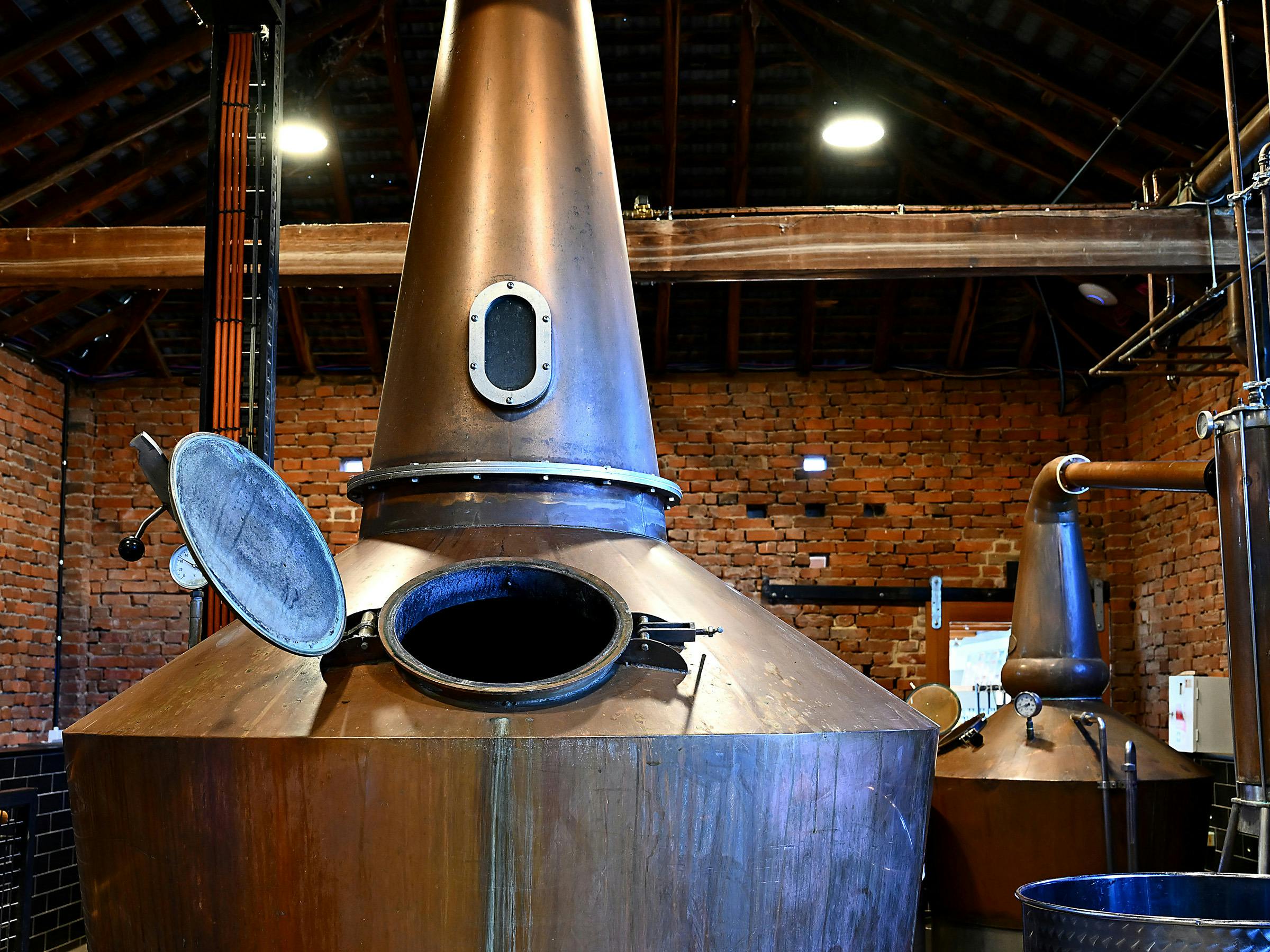 Copper whisky stills inside Clyde Mill’s brick stillhouse.