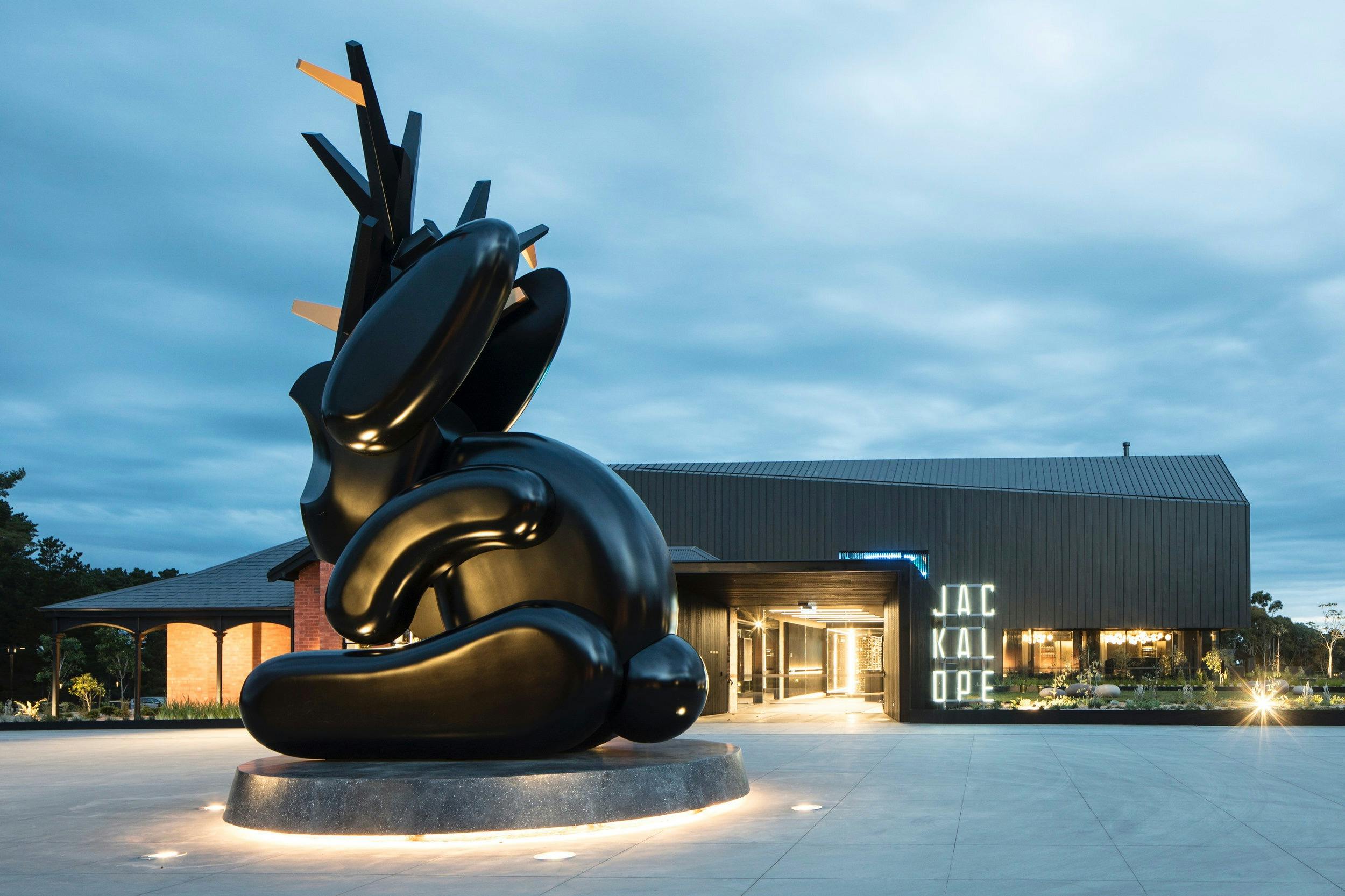 Sculpture of jackalope outside Jackalope Hotel in Mornington Pensinsula at dusk with lights on