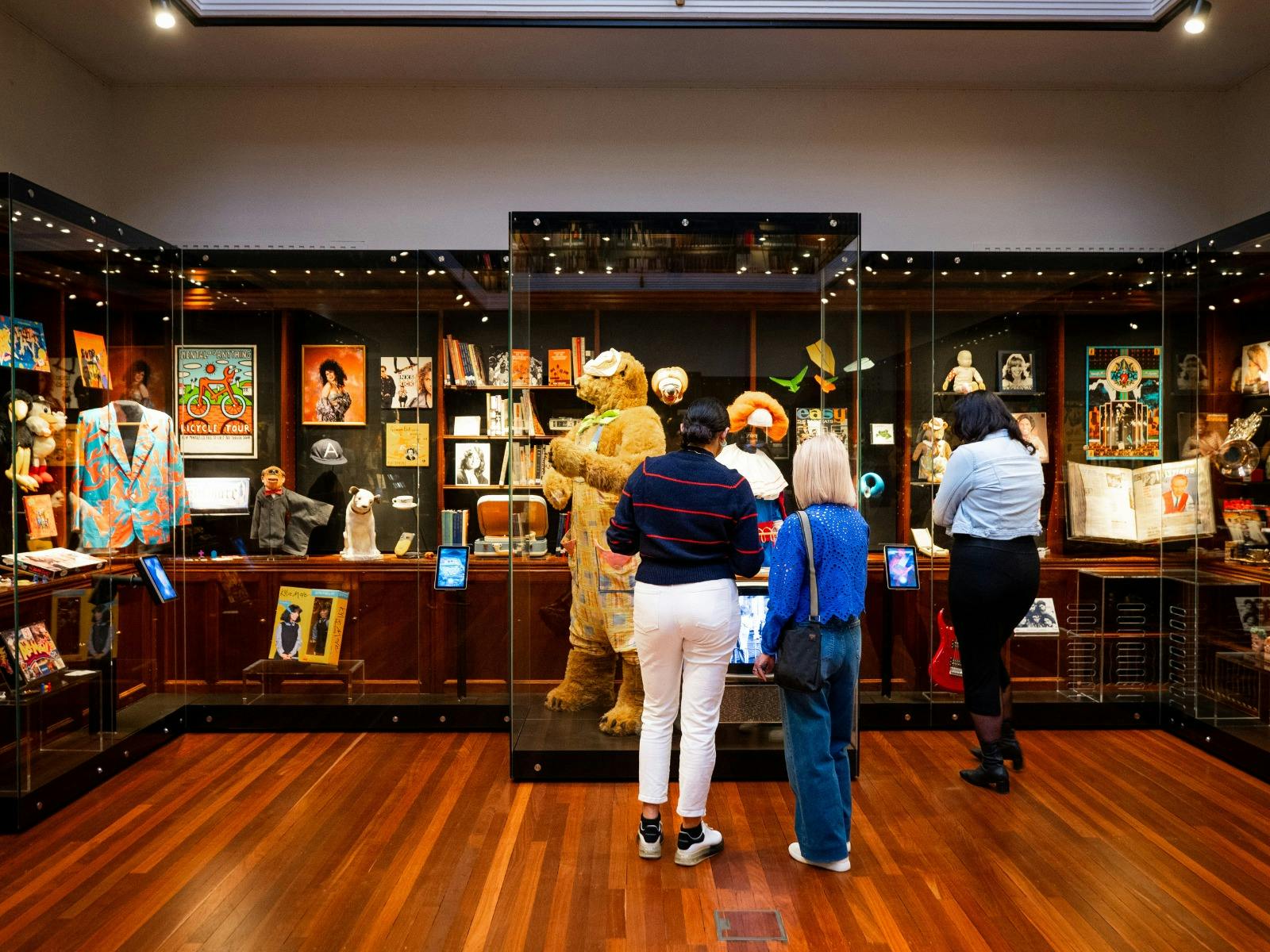 People standing in front of objects and items in an art deco space