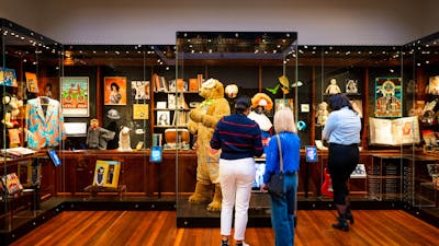 People standing in front of objects and items in an art deco space