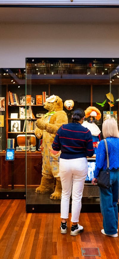 People standing in front of objects and items in an art deco space