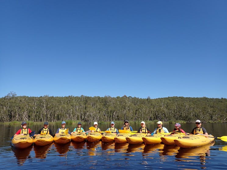 Twelve kayaks are rafted together out on the Myall Lakes National Park