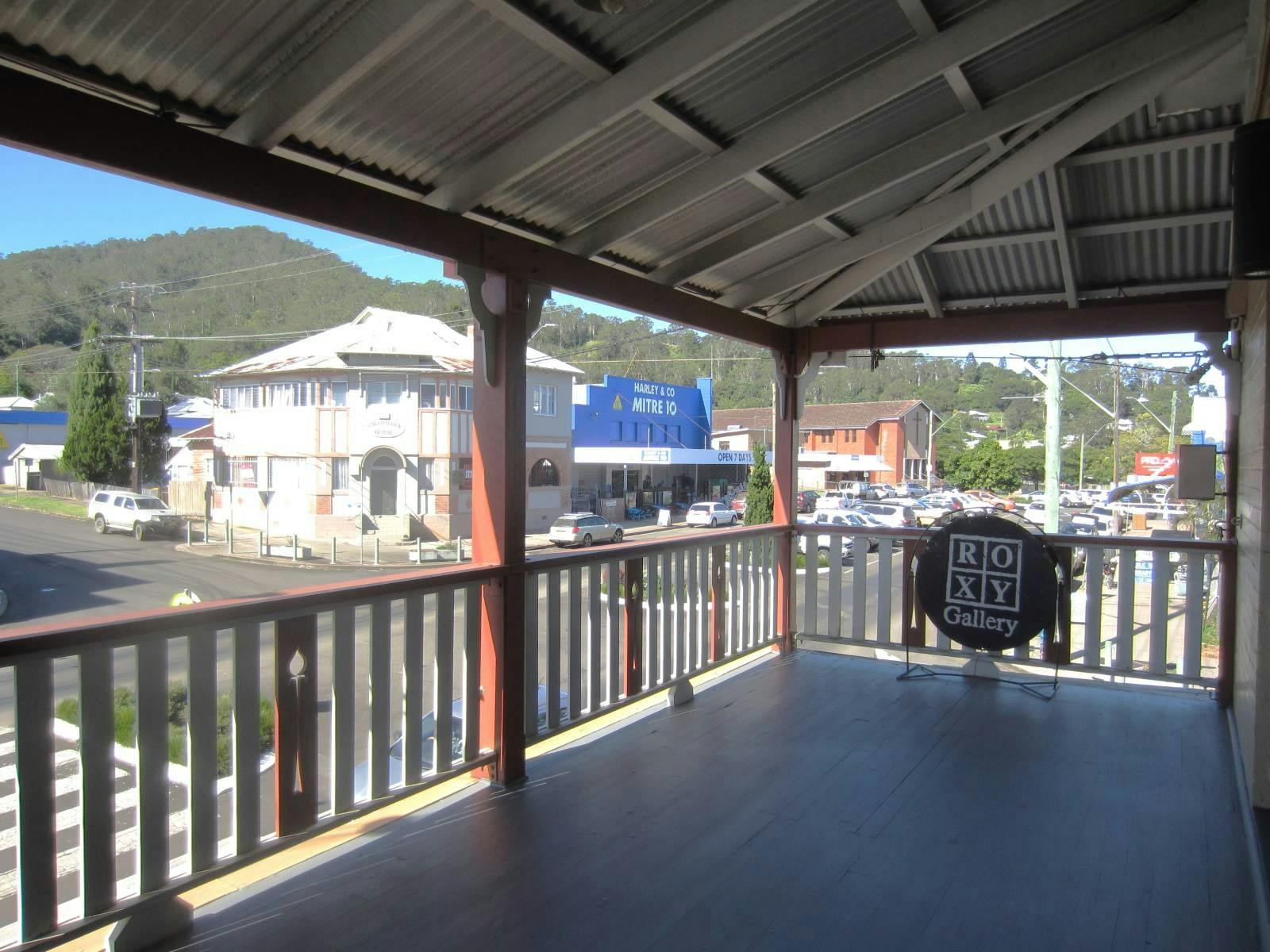 View from veranda looking out at buildings on the street and Fairymount in the background.