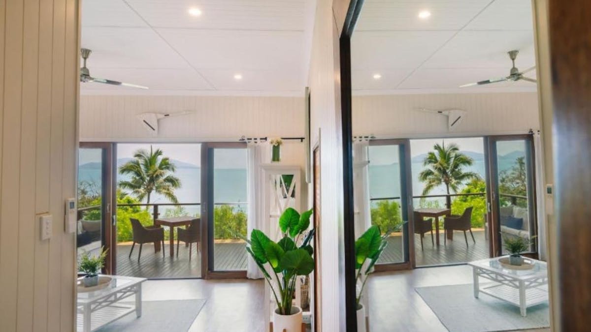 room overlooking ocean and palm trees