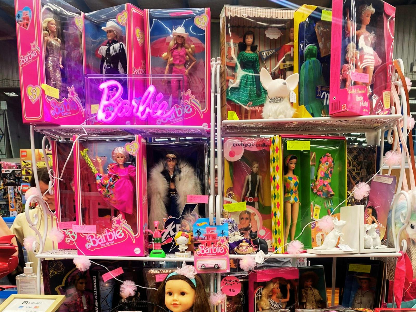 Barbie movie dolls in boxes on display