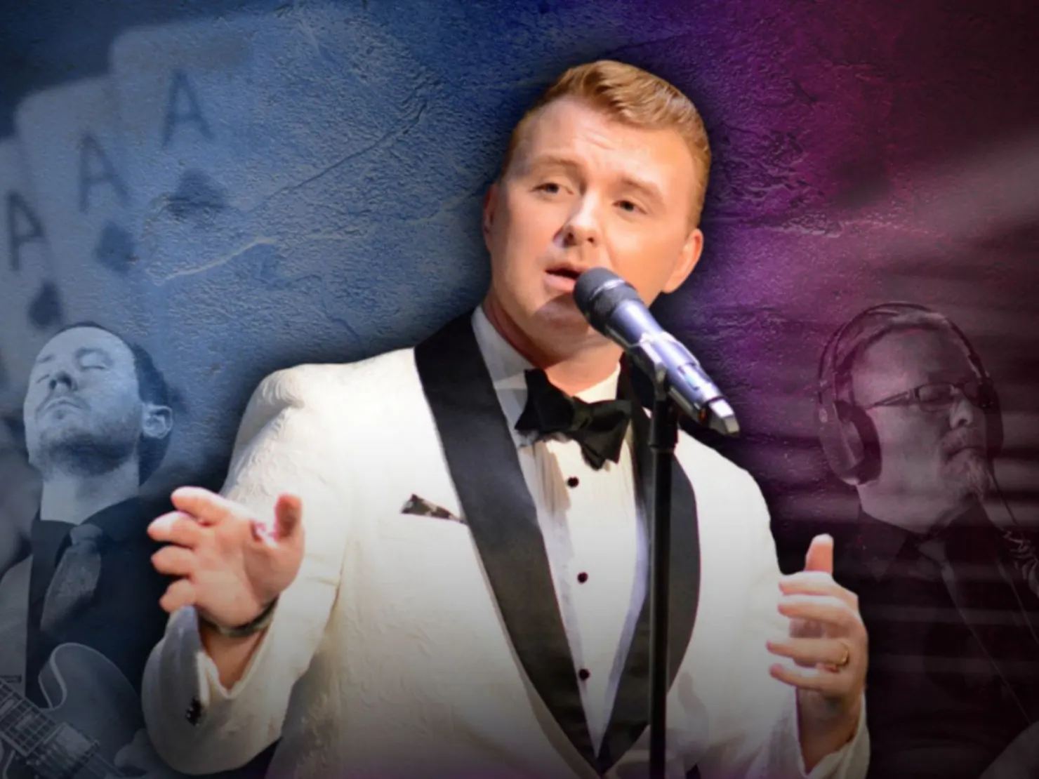 Man dressed in white tux singing at a microphone