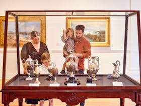 Young family looking at decorative art display at Geelong Gallery