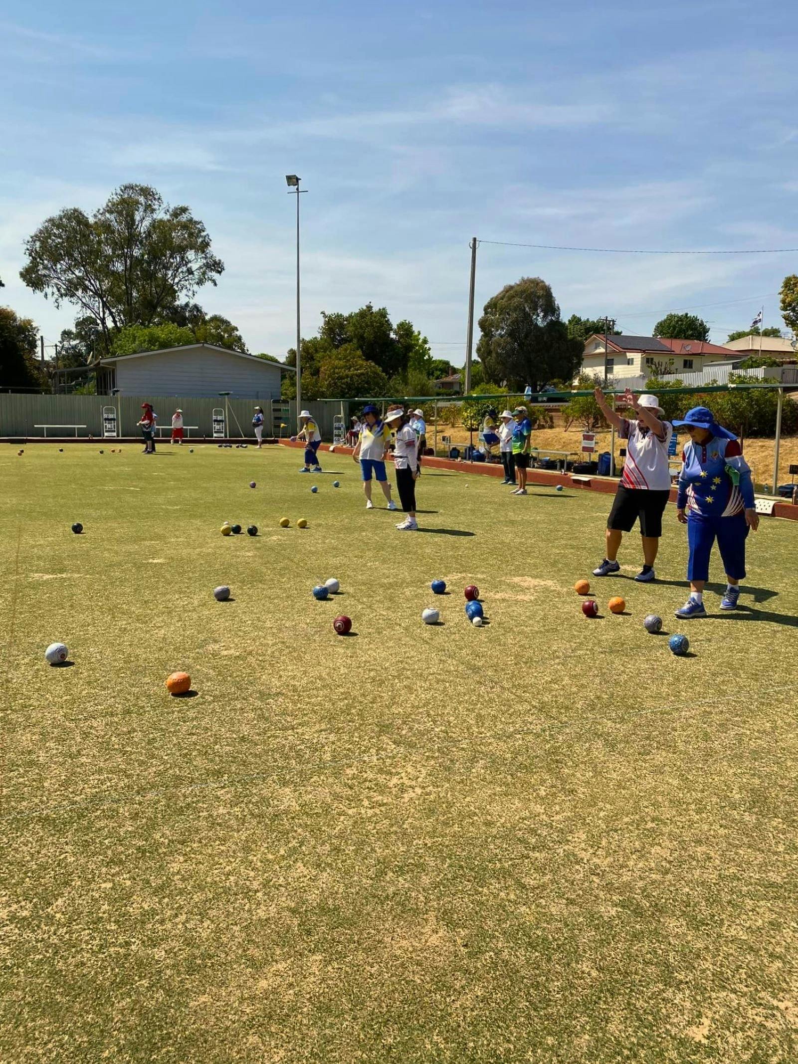 Group of women playing lawn bowls.