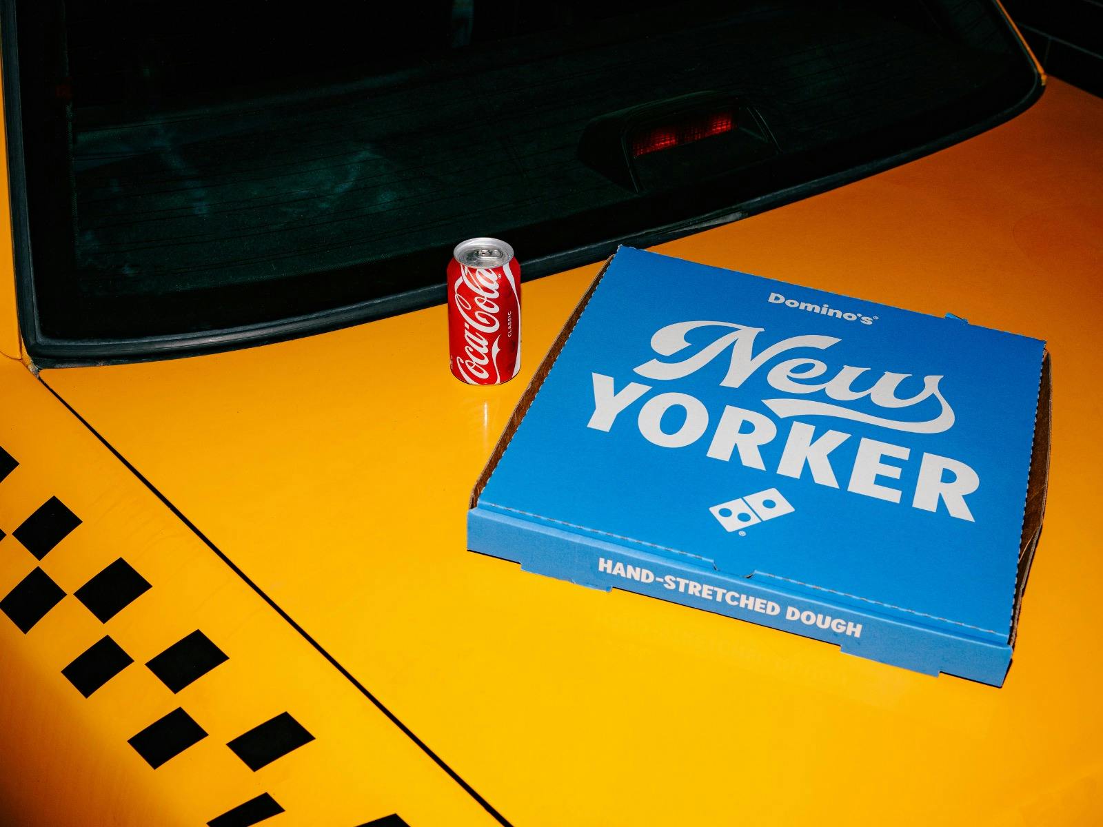 NEW YORKER PIZZA ON CAB & CAN OF COCA COLA