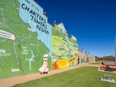 Lady walking in front of Charters Towers Wall of History 1872-1922 Lady walking in front of Charters Towers Wall of History 1872-1922