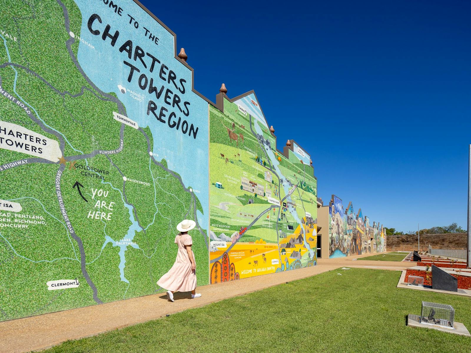 Lady walking in front of Charters Towers Wall of History 1872-1922
